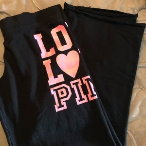 Pink- black sweatpants with hot pink lettering.